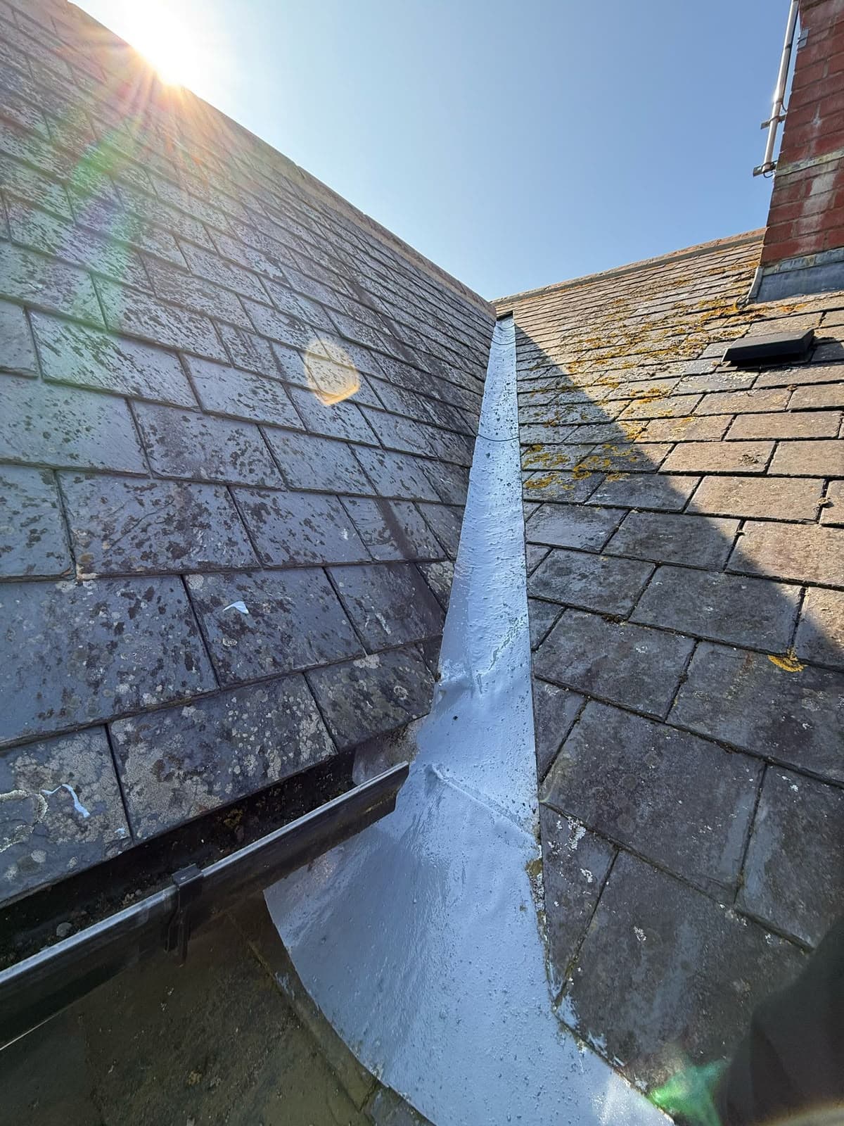 Lead-lined valley between tiled roof sections