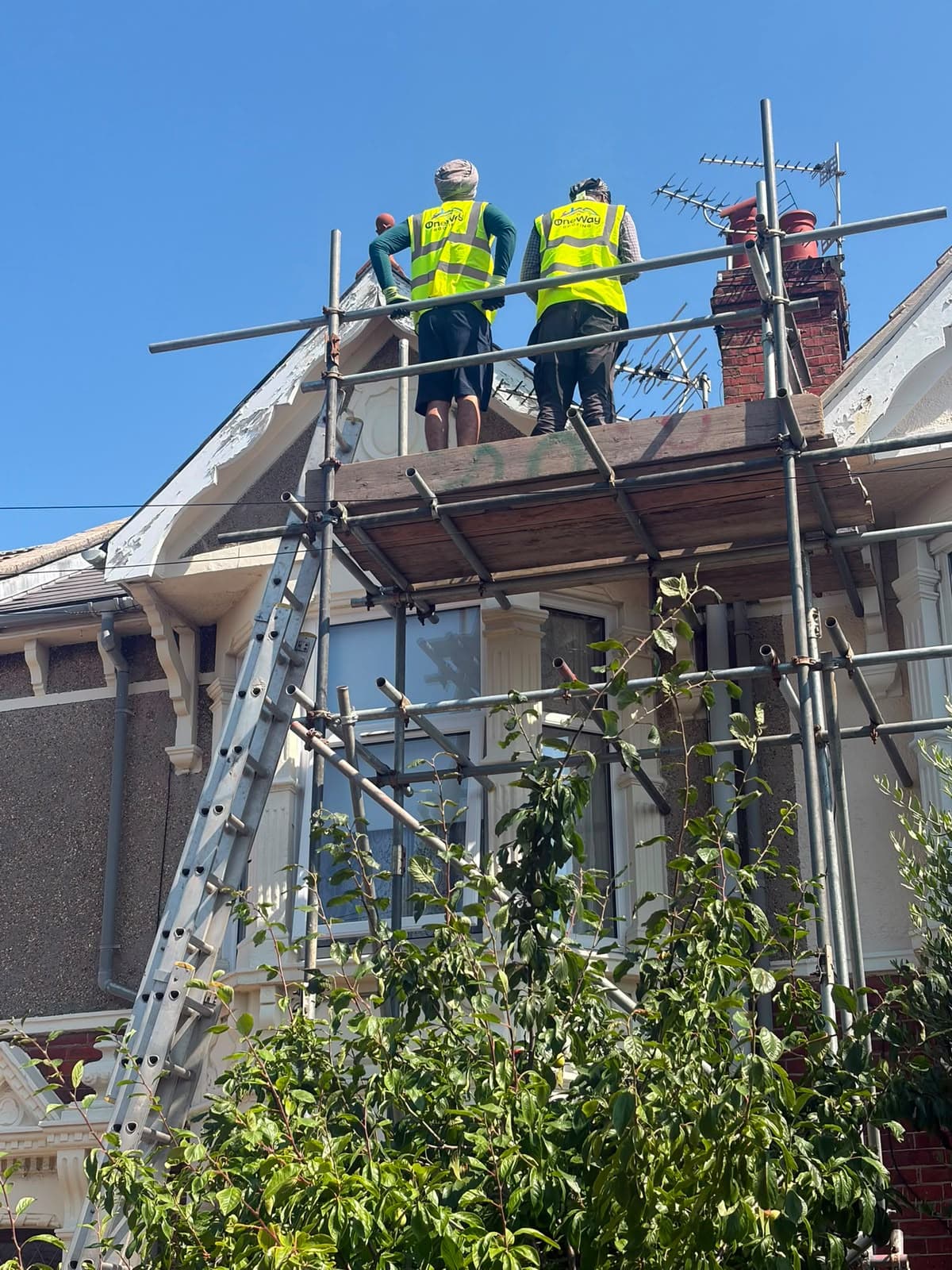 Roofers working from scaffolding